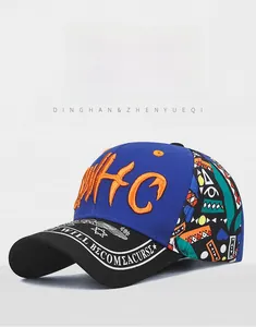 Close-up of 3D orange embroidery and graffiti pattern on a paneled baseball cap