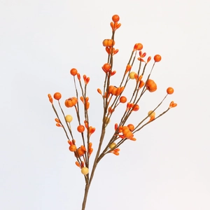Autumn Halloween decoration featuring orange faux pumpkins and berry branches on white
