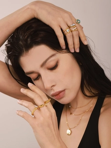 Detail of 18K gold-plated rings and necklaces with blue enamel and evil eye charms