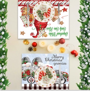 Detail of Christmas placemats featuring gingerbread man and forest gnome holiday patterns