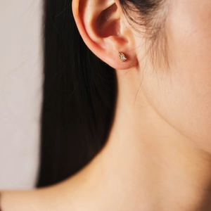 Elegant s925 silver gold floral stud earrings with white zircon on ear model