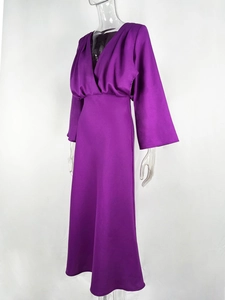 Detail of dark purple satin dress featuring elegant deep V-neck and flared sleeve design