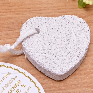 Detailed close-up of heart-shaped volcanic pumice stone with natural exfoliating texture