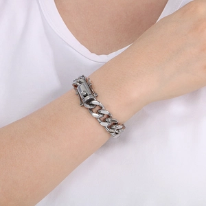 Close-up of a silver 13mm Cuban link bracelet with a secure clasp on a model's wrist