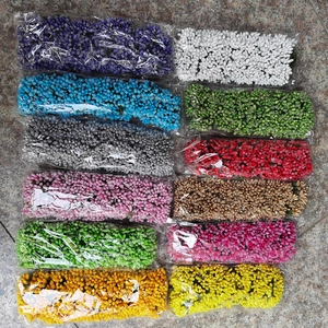 Flat lay of 12-color artificial berry stamen sets in clear bags for DIY floral crafts
