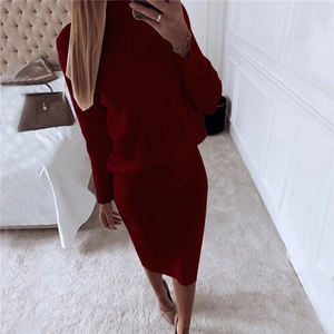 Detailed texture of dark red knit two-piece set with vertical ribbed pattern and high neck