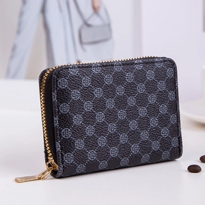 Mini square zip wallet with quilted clover print and golden hardware on white surface