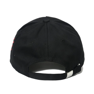 Detail of black baseball cap showing red embroidery and adjustable metal buckle