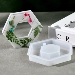 Macro view of hexagonal silicone mold for DIY resin charms with floral botanicals