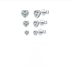 Detailed view of three pairs of S925 sterling silver heart-shaped moissanite stud earrings