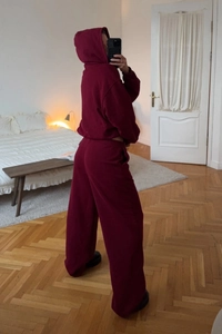 Detail of dark red lounge set featuring a zip-up hoodie and wide-leg sweatpants