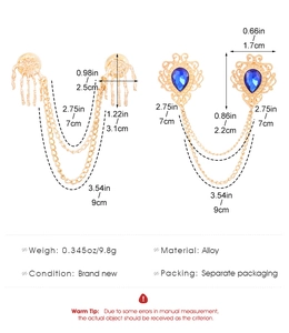 Detail showing vintage skeleton hand and blue gem collar pins with chain measurements