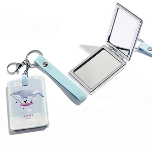 Macro detail of compact whale mirror showing both open and closed views on white background