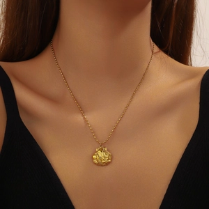 Vintage gold plated stainless steel necklace with embossed shell pattern on round pendant