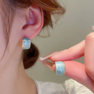 Minimalist C-shaped candy color stud earrings with blue marble texture and gold trim