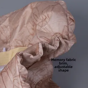 Detail of pink sun hat featuring jacquard leaf patterns and moldable memory wire brim