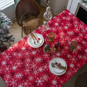 Christmas red tablecloth with snowflake prints and festive table setting decorations