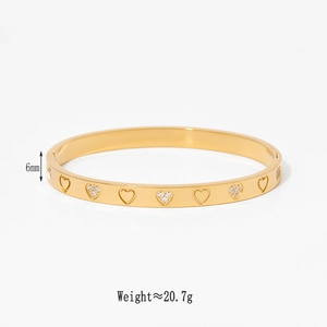 Detail showing 6mm width and 20.7g weight of gold heart stainless steel bangle