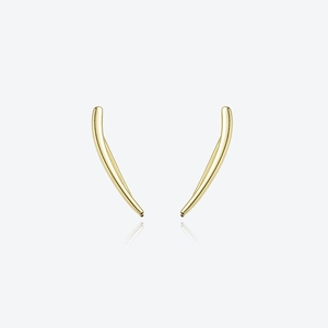 Macro detail of gold geometric curved claw earrings with minimalist metallic texture