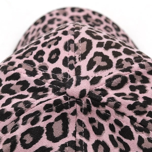 Close-up of pink leopard print suede baseball cap crown with fine stitching and fabric texture