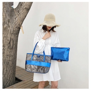 Blue metallic tote and pouch set with transparent PVC design shown in a lifestyle setting