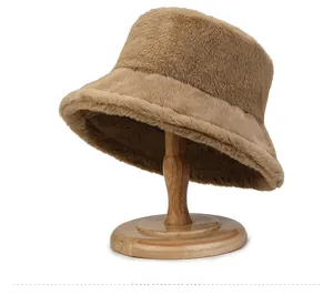Detailed side view of a thick brown plush bucket hat on a wooden stand for winter warmth