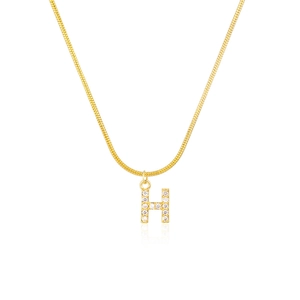 Close-up of a gold snake chain necklace with a sparkling diamond-encrusted H letter pendant