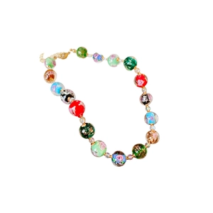 Colorful floral glass bead necklace with gold foil accents on a clean white background