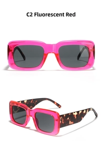 Detail of square oversized sunglasses featuring fluorescent pink frames and tortoise temples