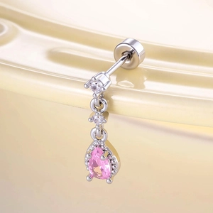 Micro-set zircon teardrop stud earring with pink stone on beige curved background