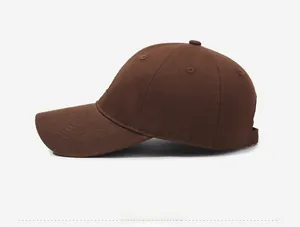 Side view of dark brown cotton twill baseball cap with curved brim and embroidered eyelets