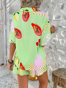 Rear view of women's green two-piece resort set featuring vibrant papaya lemon patterns