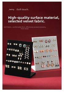 L-shaped velvet jewelry stand showing multiple earrings on a vintage red background