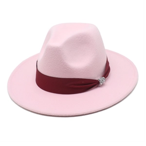 Detail of light pink fedora hat with burgundy ribbon and sparkling metal buckle