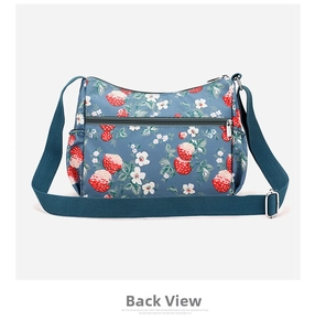 Detail view of the back zipper pocket on the blue strawberry print crossbody bag
