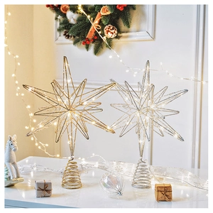 Detail of gold and silver glitter Christmas tree star toppers with warm LED lights