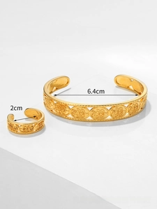 Detail of gold-plated bangle and ring set featuring intricate rose and wheat leaf carvings