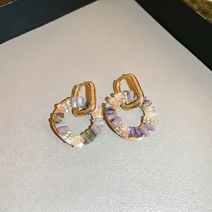 Elegant gold hoop earrings with lavender and pink crystals and sparkling white diamonds