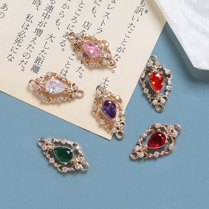 Detailed view of colorful zircon-encrusted gold-plated connectors for jewelry making