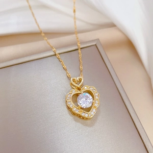 Luxurious gold heart pendant necklace with shimmering zircon stones on an elegant display