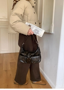 Chic retro baguette bag styled with a model in a natural indoor lifestyle setting