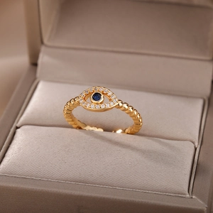 Detail of evil eye ring with blue crystal and white zirconia on a luxury jewelry box