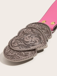 Close-up of pink studded belt with vintage floral embossed silver double heart buckle