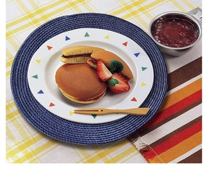 Detail of a 38cm round blue woven placemat under a plate of food on a table
