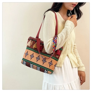 Ethnic style canvas tote bag featuring geometric patterns and decorative fringe tassels