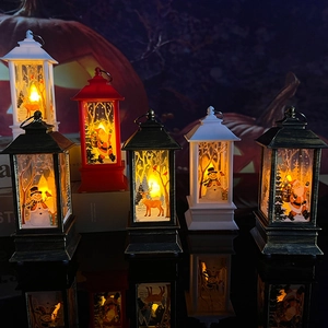 Three LED Christmas lanterns with Santa, snowman and reindeer scenes in a cozy indoor setting