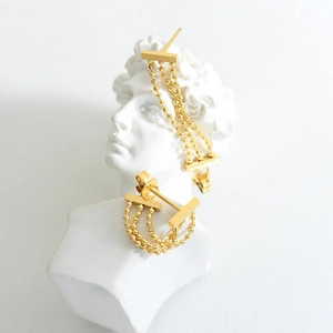 Elegant gold-plated triple bead tassel drop earrings displayed on a white David bust