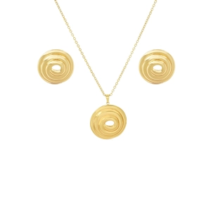 Detailed view of the gold spiral round necklace and stud earrings set on a white surface