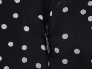 Macro view of black and white polka dot fabric with high quality invisible zipper detail