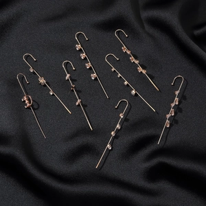 Gold ear cuff set with cubic zirconia stars and moon on black satin background